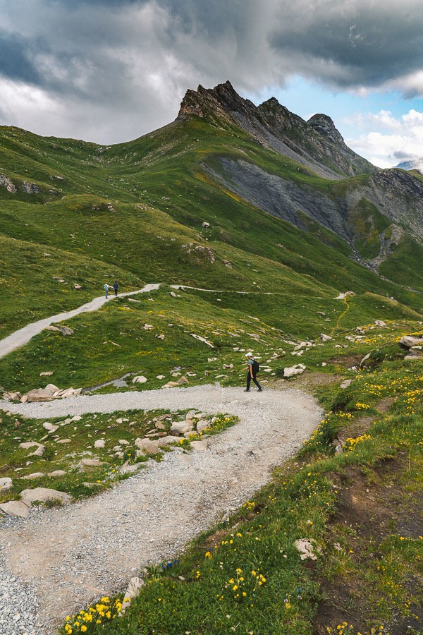 a person walking on a trail in the mountains.