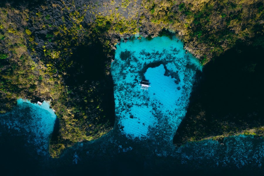 an aerial view of a boat in the water.