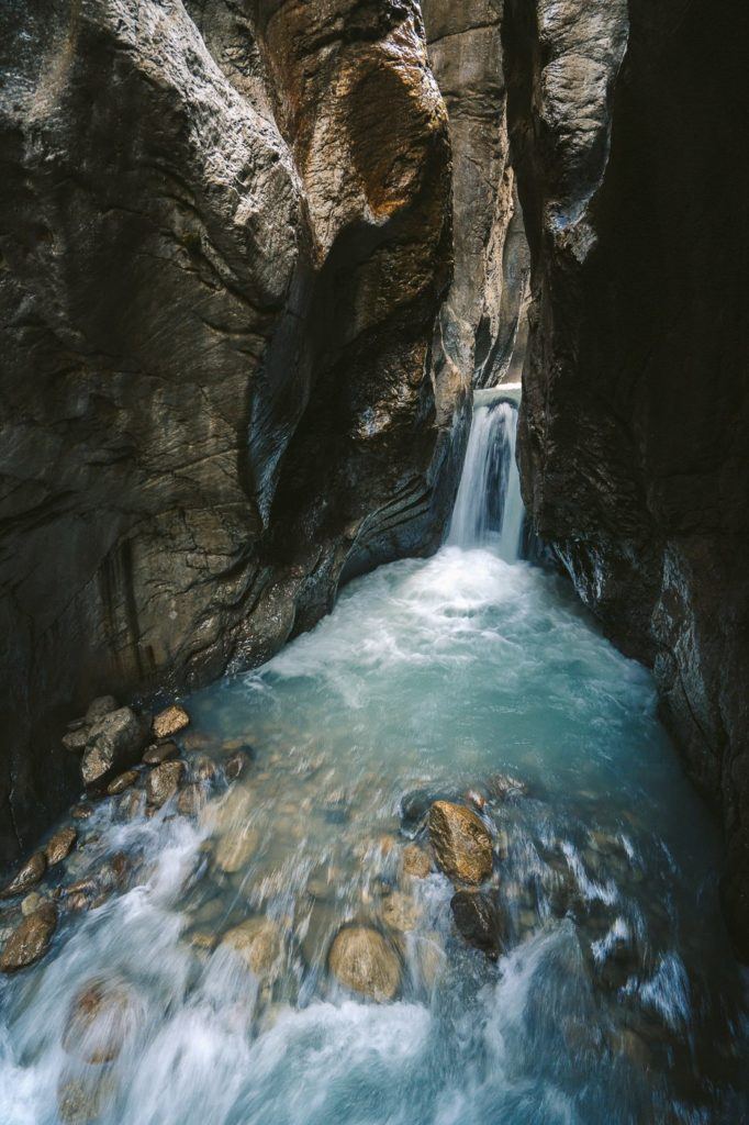 a river flowing through a narrow canyon in the mountains.