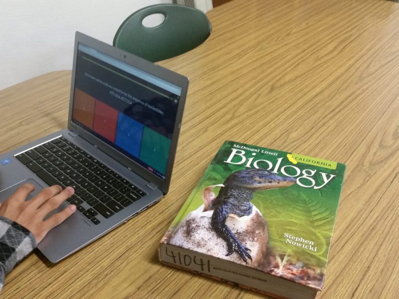 A special education student at South Hills High School takes an online quiz about RNA. The district’s reforms to special education have included making sure students use the same textbooks as their general education peers.