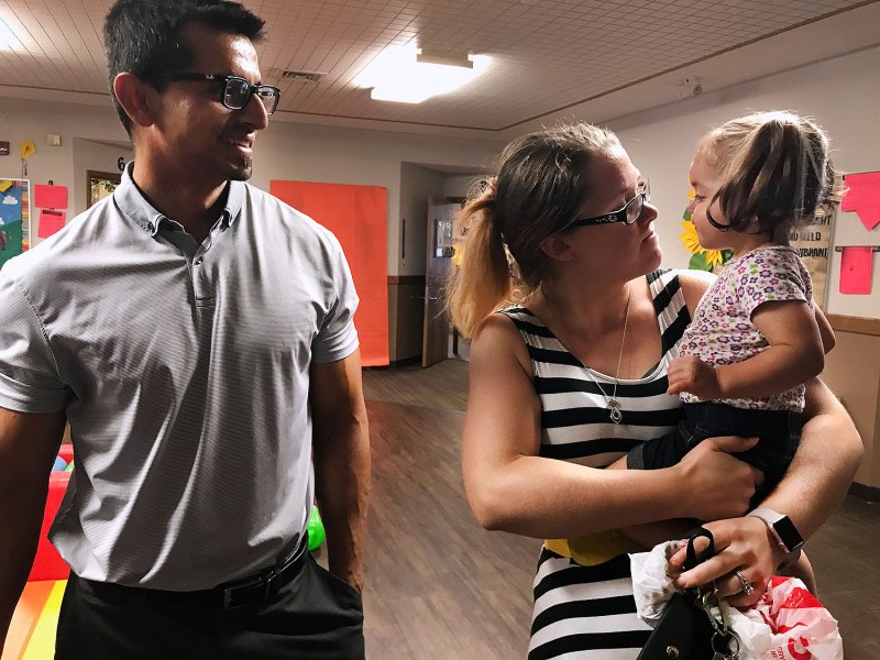 Arif and Meghan Sheikh smile at their younger daughter, Amelia, 1, while picking her up from her child care center. After struggling to find care for their older daughter, the Sheikhs put Amelia’s name on the waiting list here when Meghan was just a few months pregnant.