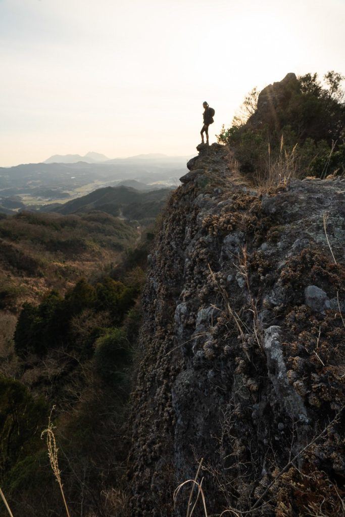 a person standing on top of a cliff.
