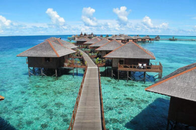 A pier leading to several overwater bungalows in Malaysia.