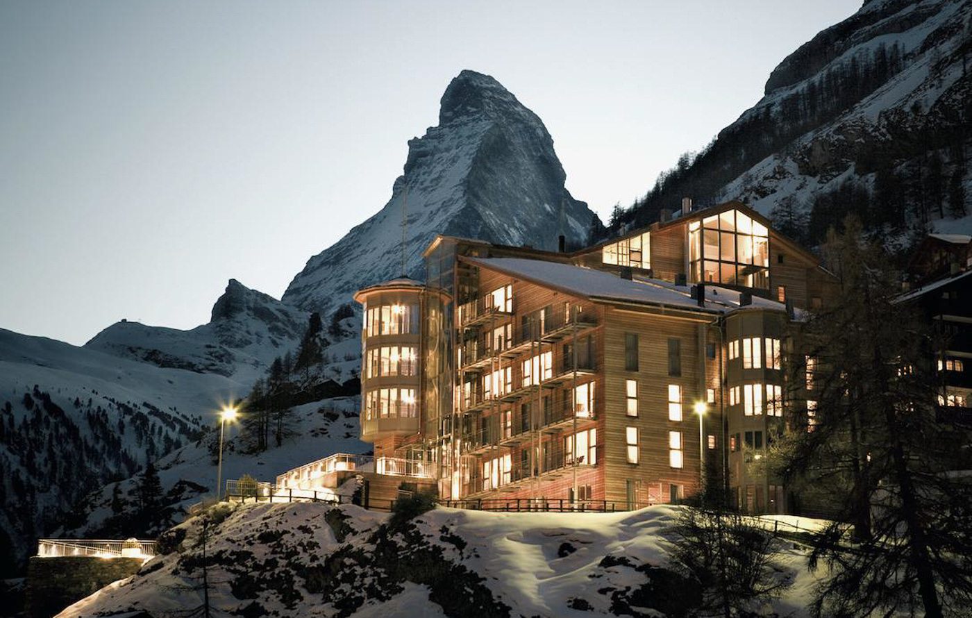 a building with a mountain in the background.
